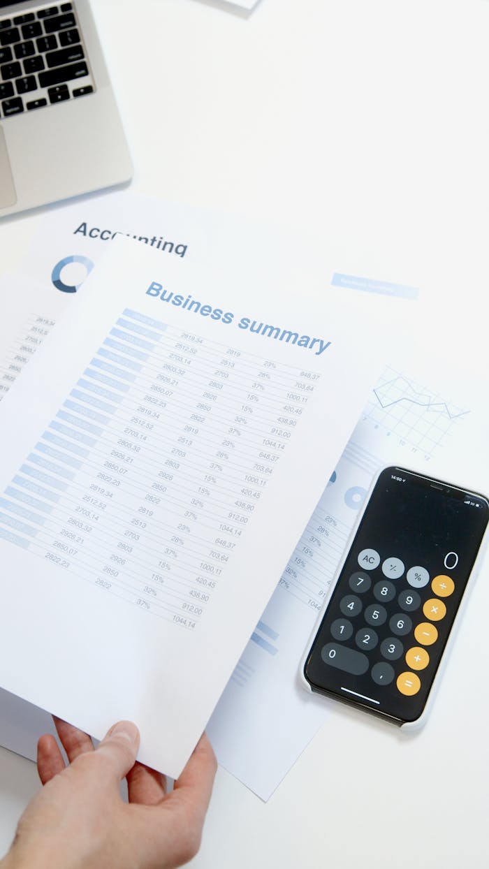 services-04 Business summary sheet with a calculator on a desk for financial analysis.